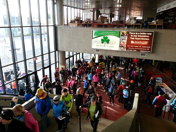 Participants, supporters and volunteers keep warm inside FirstOntario Centre before the race (RTH file photo)