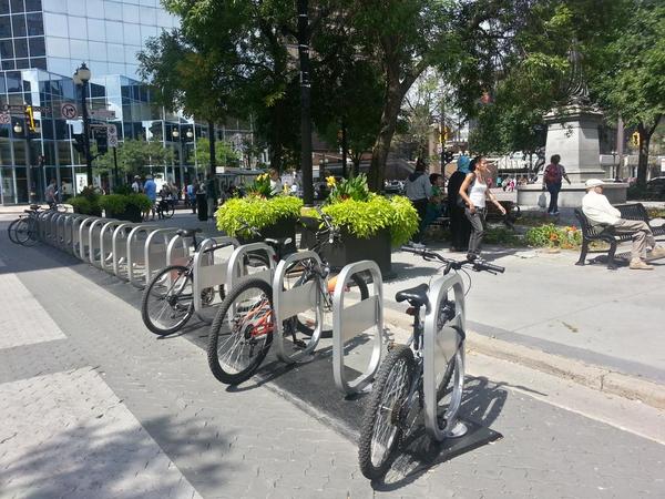 Bike share station at Gore Park, King and James, already in use as bike parking