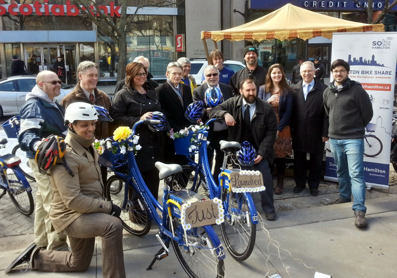 From left: Brad Tyleman, Hamilton Cycling Committee; Matthew Green, Ward 3 Councillor; Paul Miller, MPP for Hamilton East-Stoney Creek; Monique Taylor, MPP for Hamilton Mountain; Gerry Davis, Public Works General Manager; David Christopherson, MP for Hamilton Centre; Gene Wasik, Hamilton Bike Share Executive Director; Ted McMeekin, MPP for Ancaster-Dundas-Flamborough-Westdale; Sean Burak, Hamilton Bike Share Operations Manager; Peter Topalovic, Public Works Manager for transportation demand management; Jason Farr, Ward 2 Councillor; Chelsea Cox, Hamilton Bike Share Community Manager; Chris Burke, Metrolinx director of service planning; Justin Wiley, Social Bicycles Vice President of business development