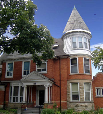 274 Bay South, 1892 Queen Anne style with conical corner tower, and varying brick and stone.