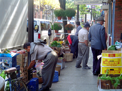 Vendors unload their wares on sidewalk displays