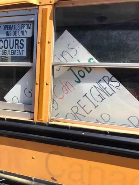 Racist sign in the window of the Yellow Vest bus (Image Credit: Tanya Ritchie)