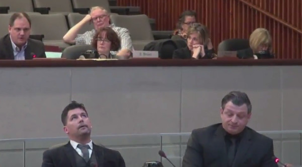 Councillor Collins, bottom left, continues to roll his eyes slowly as Paul Johnson, top left, responds to a question from Councillor Merulla, bottom right (Image Credit: screen capture from TPR video)