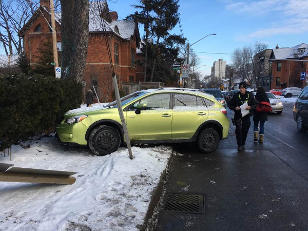 Car sitting across Queen Street sidewalk on February 6, 2018 (Image Credit: Maureen Wilson)