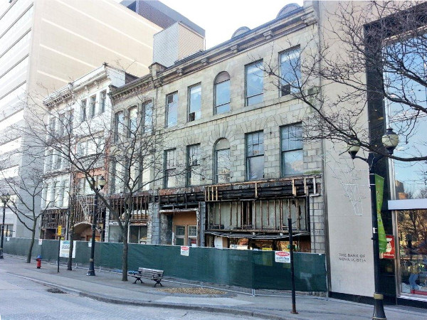 Gore buildings with their facades removed, surrounded by fencing