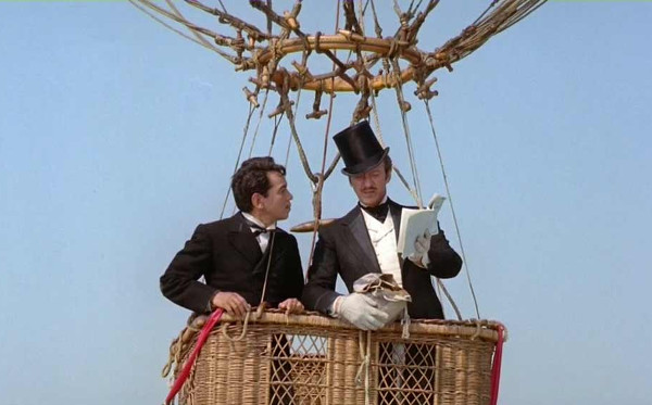 Mario Moreno (Cantinflas) as Passepartout and David Niven as Phileas Fogg consult a ballon flying manual in the 1956 film 'Around The World in 80 Days'