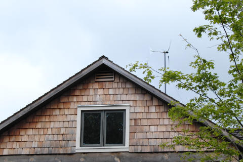 Braden's wind turbine pokes out from behind his house.