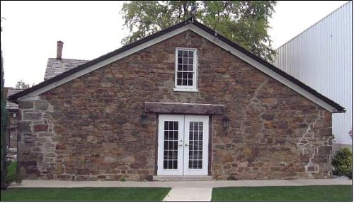 Figure 3. Cottage on the E.D. Smith property, Winona. Built as a farm building in 1835. The stone is local fieldstone, mostly Silurian Grimsby sandstone derived from the Niagara escarpment. The worn shapes are evidence that it was not derived from a quarry.