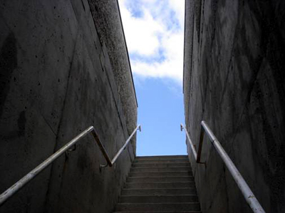 The stairwell frames the sky like a James Turrell Skyspace installation