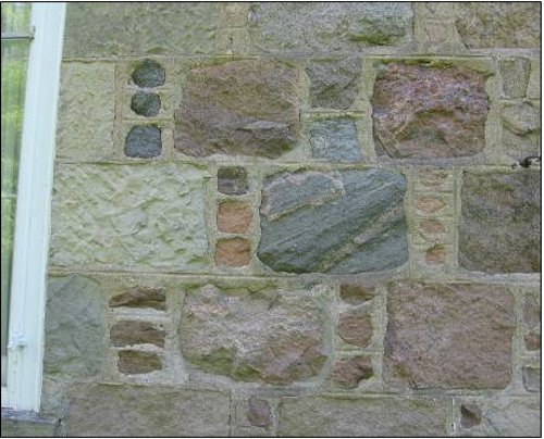 Figure 10. Detail of the side of the house shown in Figure 9. Note the variety of stones, and the careful shaping and arrangement in regular courses. The pattern of inserting a single column of 3-4 smaller stones between the larger stones is typical of Scottish stonemasonry, and is called 'Aberdeen bond.'