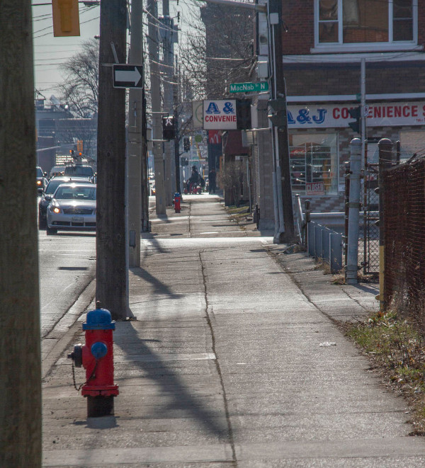 The street is inhospitable and few pedestrians dare walk along it