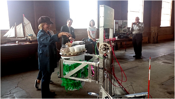 A student-built robot serves coffee and treats at the 2015 Hamilton Maker Faire media launch