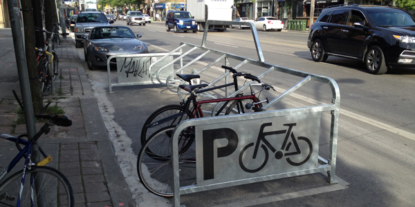 A bike corral on College St. in Toronto is a local example of what new bike corrals in high-density cycling areas could (and should) look like.