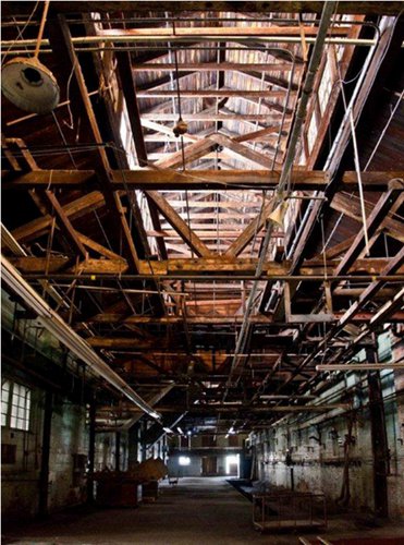 Portion of extra-large non-landmark building in downtown Hamilton. Note culturally irrelevant heavy timber truss construction of interior. Interior image: Carla Mackie.