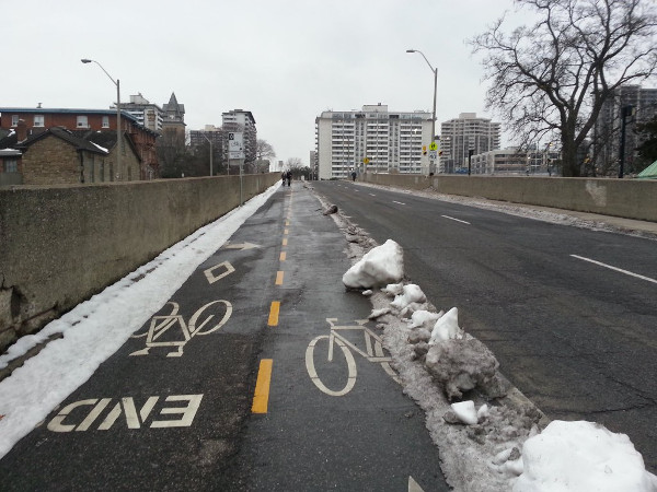 Hunter Street bike lanes protected by ice piles (Image Credit: Ryan McGreal)