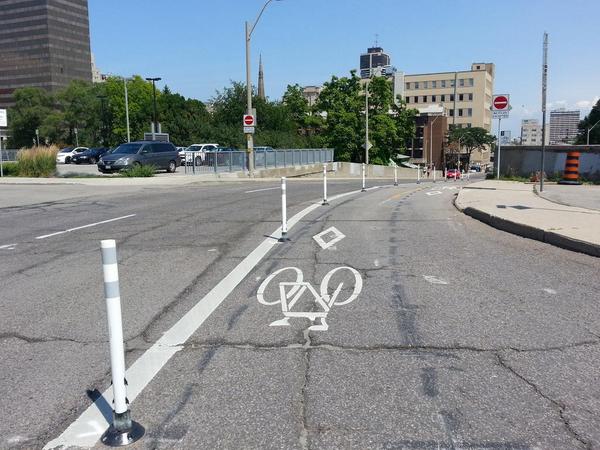 Knockdown sticks installed on Hunter Street bike lanes, looking east from Park Street