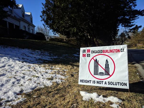 Lawn sign opposing tall buildings in downtown Burlington (RTH file photo)