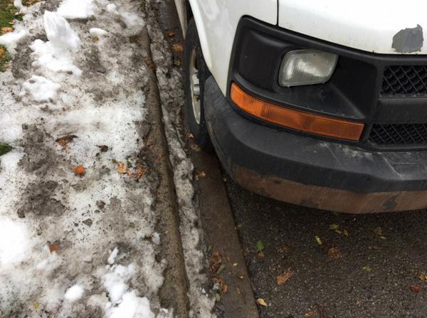 Photo #2: Close up of right front tire of white van in foreground of photo #1