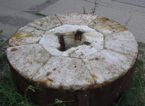 Figure 6: Millstone at the Snowball mill in St. George, Ontario. Note its construction from segments of chert, probably imported from France (it has now been broken into several parts).