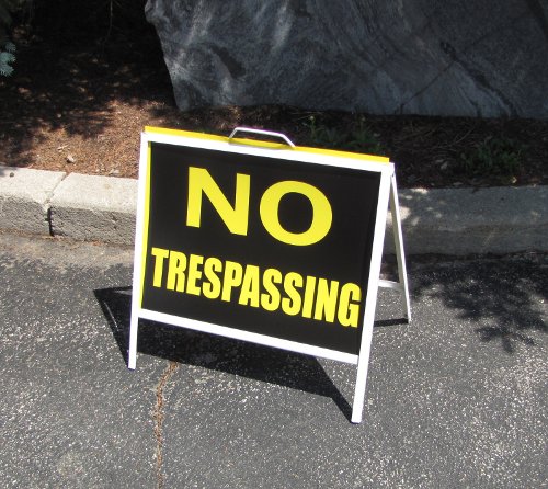 No Trespassing sign in front of the strip mall housing MP David Sweet's constituency office