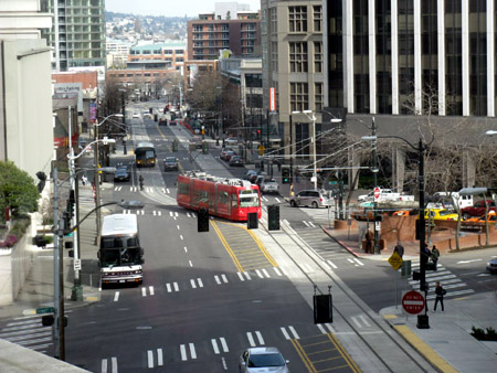 A modern streetcar winds its way through downtown Seattle.