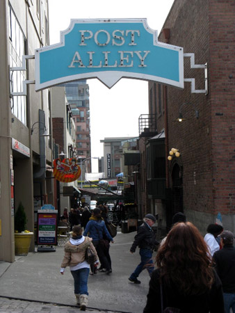 A market alleyway lined with cafes, shops and restaurants.