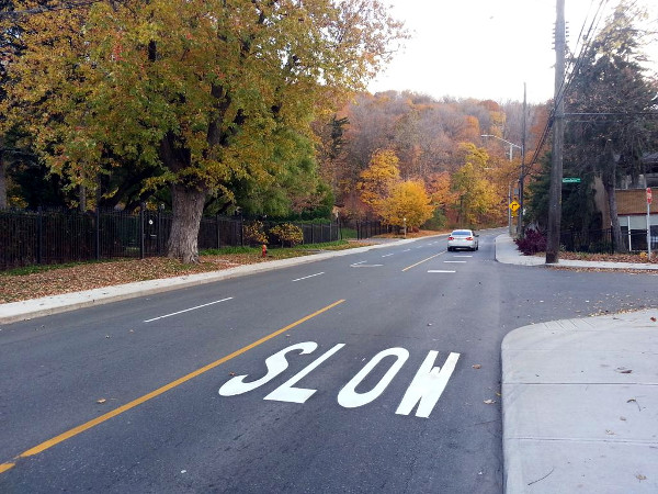 SLOW painted on Queen Street at Glenfern