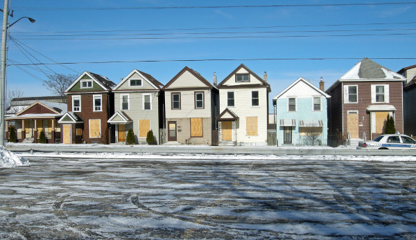 Houses on the north side of Barton at Caroline. Just visible at the left is the roofline of a large clerestory building, also demolished.