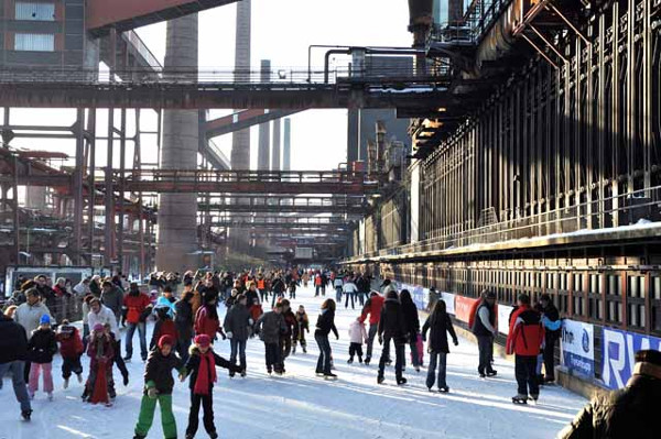 Family time among the coke ovens. The deactivated Zollverein coal mine and coking plant in the Ruhr Valley is very much in use as a culture and recreation centre and tourist attraction on the European Route of Industry. Image Credit: Manfred Vollmer.