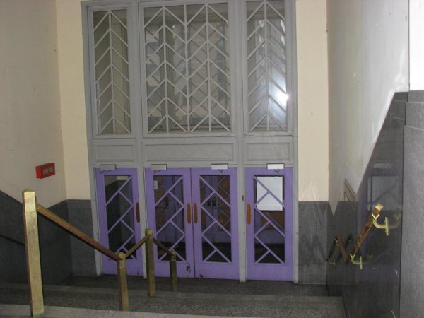 Brass rails, terrazzo floors, walls, doors in entrance hallway in excellent shape.