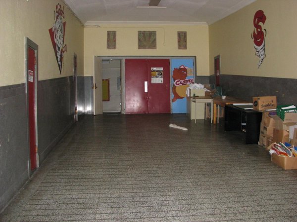 Terrazzo floor, walls and ceiling on main floor hallway to gym in excellent shape.