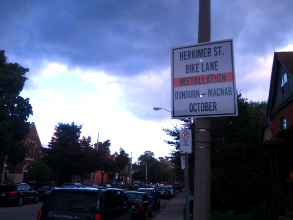 Sign announcing planned bike lane installation on Herkimer Street (Image Credit: Kyle Slote)