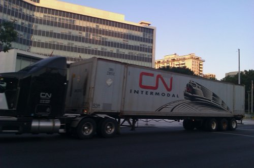 A transport truck passes City Hall on Main Street (RTH file photo)