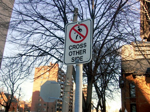 'Pedestrians Cross Other Side' sign on the east side of Hughson at Charlton