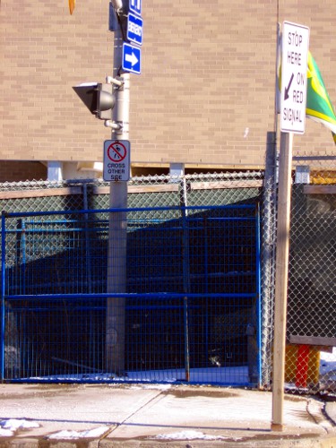 'Pedestrians Cross Other Side' sign on the south side of Herkimer at James