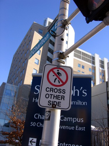 'Pedestrians Cross Other Side' sign on the south side of Charlton at James