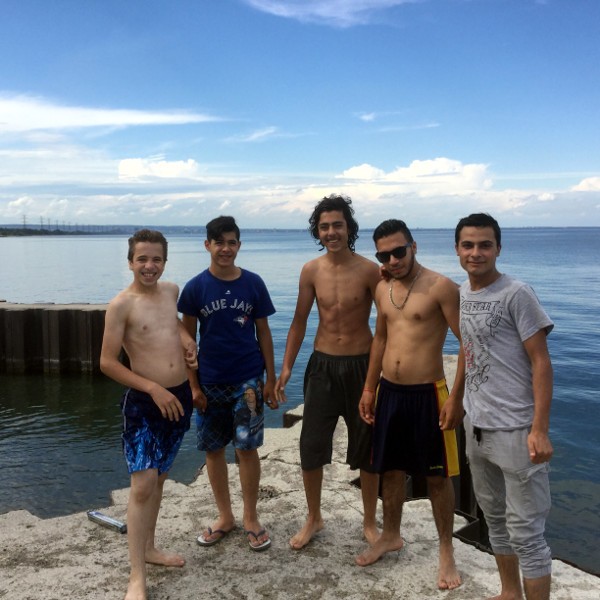 These boys are from Syria and arrived in Canada 6 to 8 months ago. They were east of Barangas having a wonderful time jumping off and into the water.